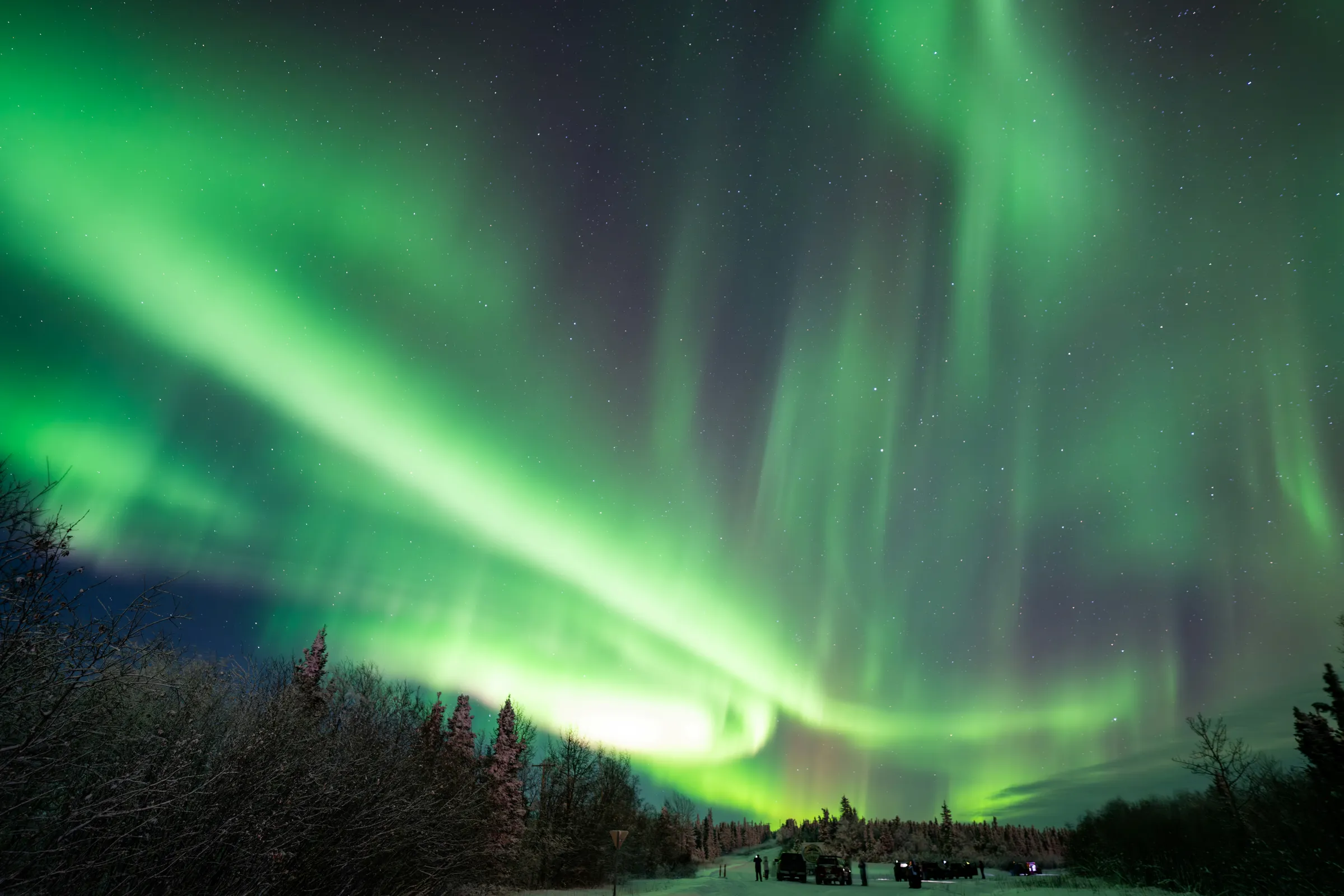 Northern lights over a snow-covered road in Alaska